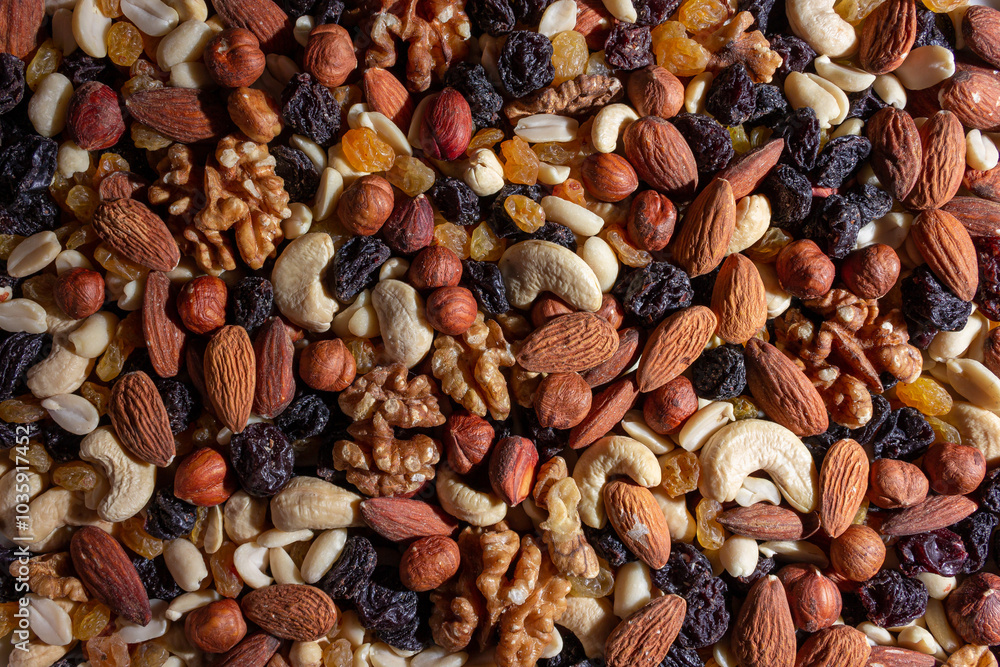 Mixed Nuts: Almonds, Walnuts, Cashews, Peanuts, Hazelnuts, Dried Prunes and Raisins. Different Nut Mix. Background from Various Nuts and Dried Fruits Mixed Nuts: Almonds, Walnuts, Cashews, Peanuts, Hazelnuts, Dried Prunes and Raisins. Different Nut Mix. Background from Various Nuts and Dried Fruits