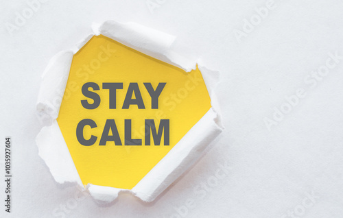 Stay Calm Message Written on Yellow Paper Under Ripped White Paper