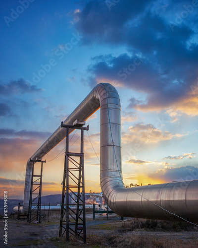 Geothermal energy. Pipeline of a plant at sunset in Larderello, Tuscany region, Italy