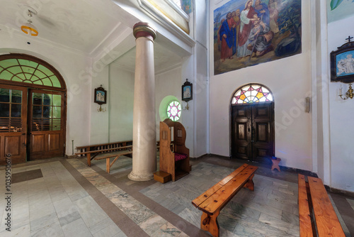 SOLY, BELARUS - SEPTEMBER 12, 2024: interior of old catholic church with columns and frescoes photo