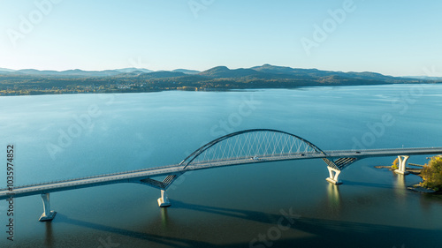 Fototapeta Naklejka Na Ścianę i Meble -  Aerial view of Lake Champlain Bridge, spanning the serene lake and connecting Crown Point, New York to Vermont.