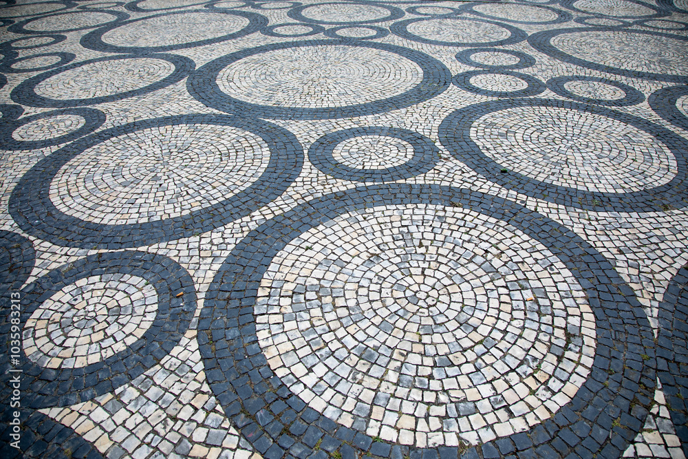 Mosaic Paving Tiles in Aveiro, Portugal. Traditional Portuguese paving slabs. Basalt and limestone stones of black and white colors are traditionally used for patterns Mosaic Paving Tiles in Aveiro, Portugal. Traditional Portuguese paving slabs. Basalt and limestone stones of black and white colors are traditionally used for patterns