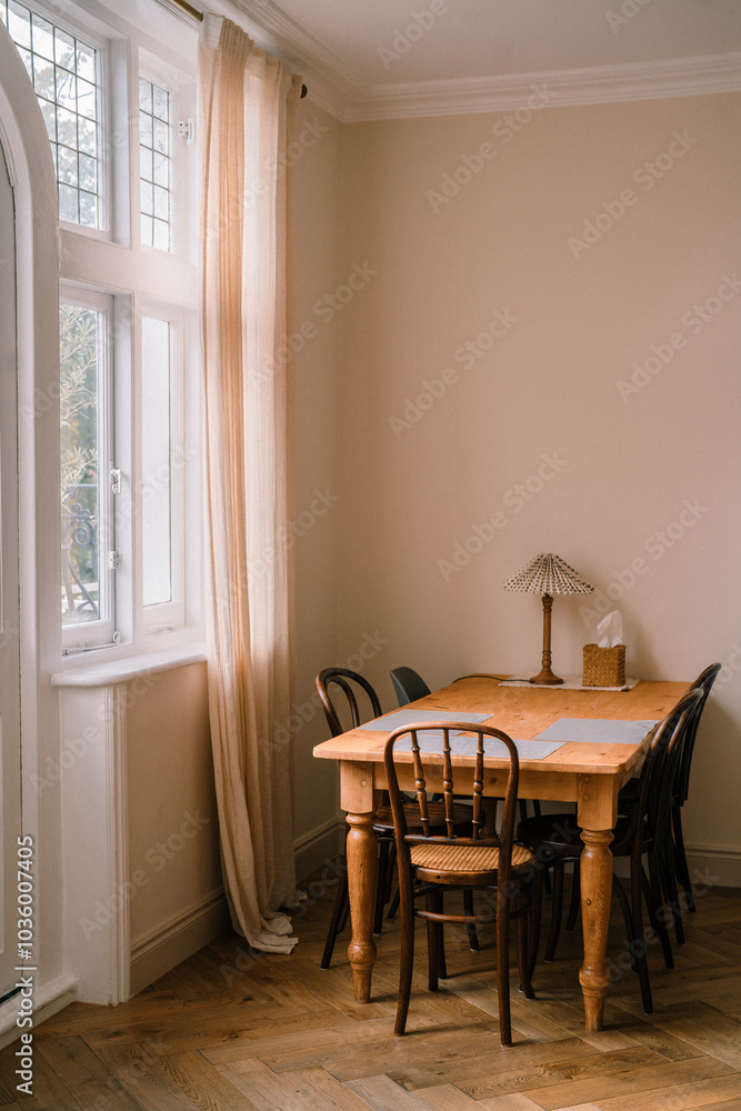 Spacious dining room with wooden farmhouse table in vintage style