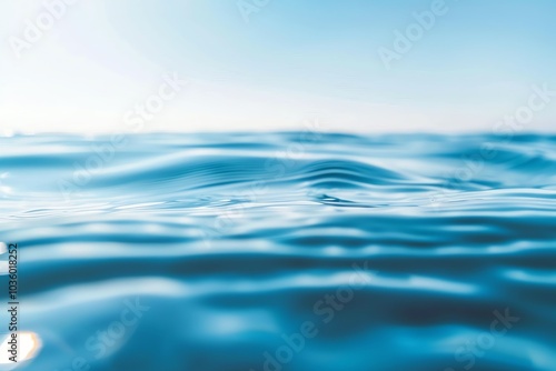 Calm water surface with gentle waves reflecting sunlight, evoking tranquility and peace in nature.