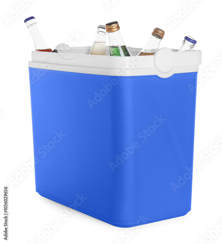 Many bottles of drinks in cooler box isolated on white photo