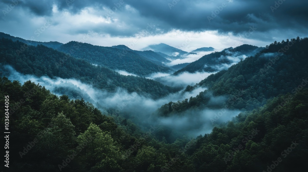 Dark clouds covering a mountain range as a storm moves in, with fog rolling through the valleys Dark clouds covering a mountain range as a storm moves in, with fog rolling through the valleys
