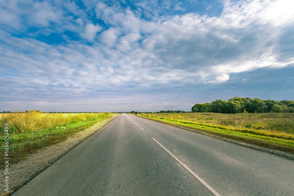 A long road with a clear blue sky in the background A long road with a clear blue sky in the background