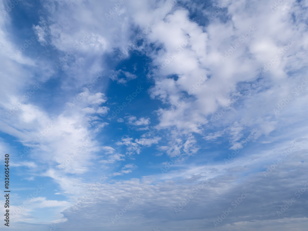 A striking view of a blue sky filled with scattered clouds, creating a serene atmosphere and evoking feelings of peace and tranquility A striking view of a blue sky filled with scattered clouds, creating a serene atmosphere and evoking feelings of peace and tranquility