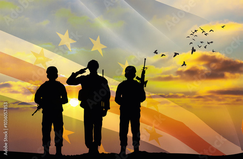 Silhouettes of soldiers with a background of the Cabo Verde flag and a sunset or sunrise. Concept of national holidays. Commemoration Day. photo