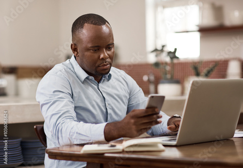 Black man, typing and phone with laptop at house for financial planning, review budget and schedule. Male person, mobile and accounting research, audit report and investment funding for project goal