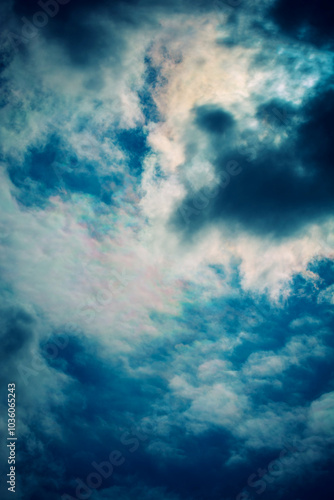 Dramatic cloudy sky displaying deep blues and contrasting shadows, creating a moody atmosphere.