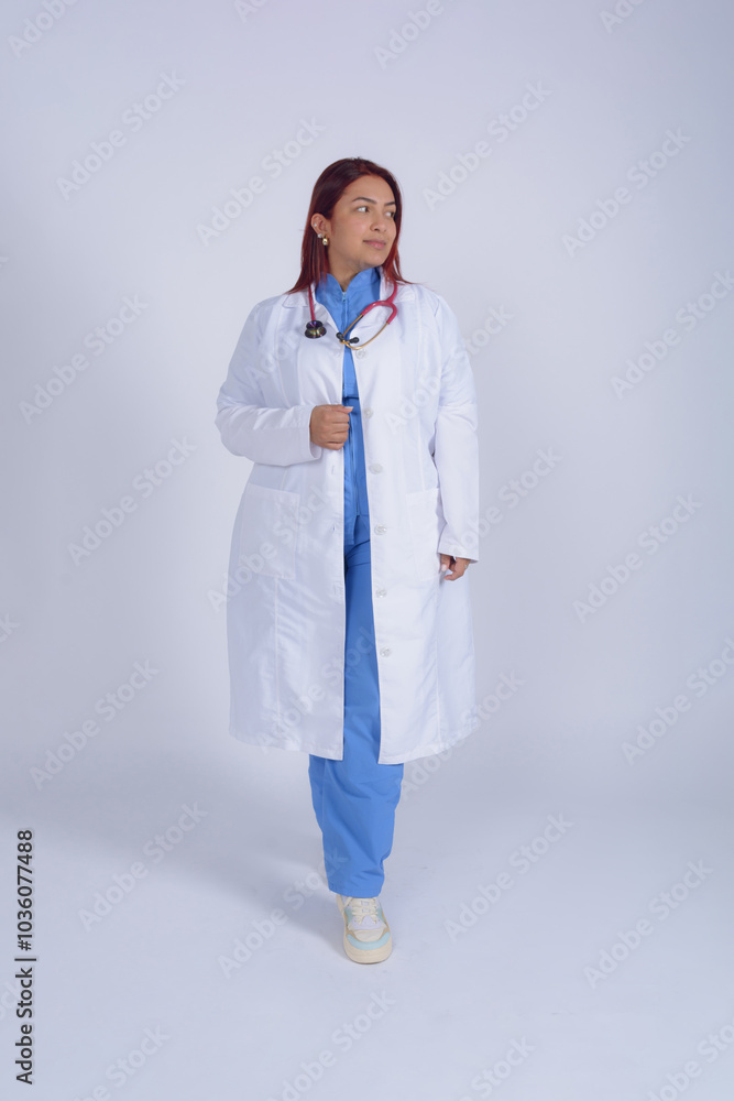 Female doctor in uniform posing looking to the side, wearing a stethoscope, vertical image Female doctor in uniform posing looking to the side, wearing a stethoscope, vertical image