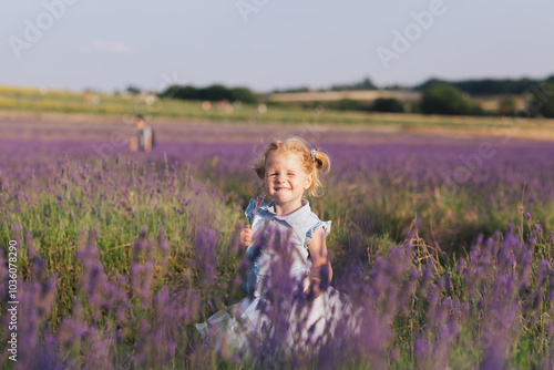 Cute adorable happy smiling ginger-haired little girl in a ballerina tutu in a lavender field