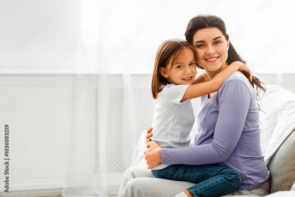 Portrait of happy pregnant woman and her little daughter hugging each other at home Portrait of happy pregnant woman and her little daughter hugging each other at home