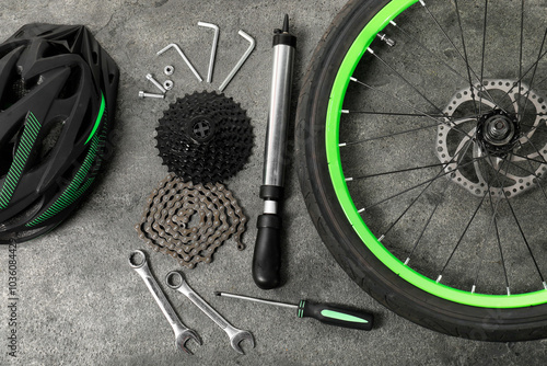Quadro su tela Parts of bicycle and tools on grey background, flat lay