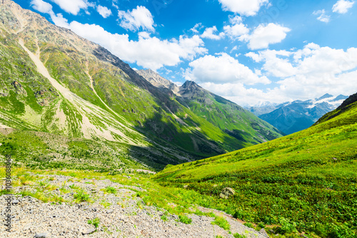 Beautiful high mountain landscape with green slopes and large stones. Caucasus, Elbrus region.