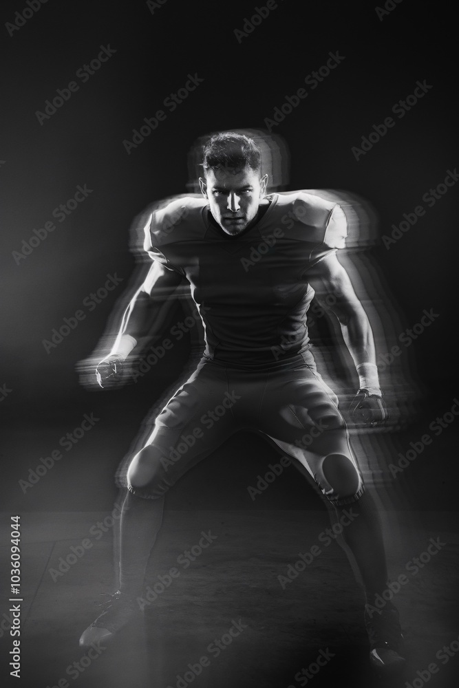 American Football Player in Action: A dynamic, motion-blurred image of an American football player in a powerful stance, ready for the next play. American Football Player in Action: A dynamic, motion-blurred image of an American football player in a powerful stance, ready for the next play.