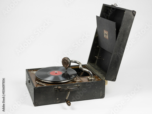 Early 20th-Century Vintage Portable Gramophone with Vinyl Record Isolated on White Background