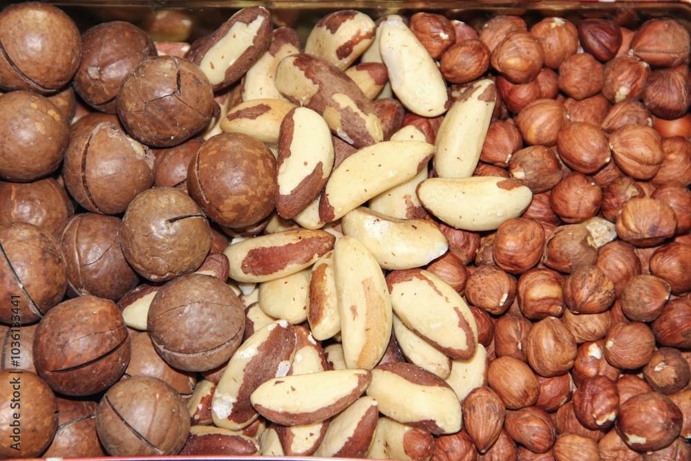 Obraz premium A close up shot of an iron box filled with assorted nuts, white background.