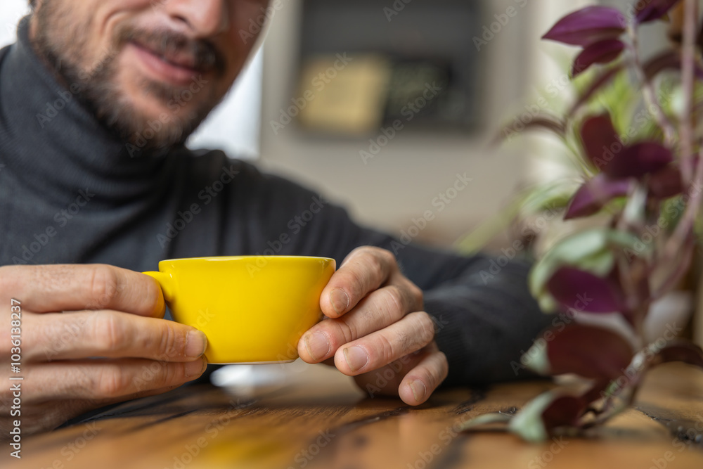 Close-up happy young man smiling in a cafe holding a cup of matcha tea, art with heart shape milk, cappuccino coffee with foam and heart, espresso coffee, decoration with plants, vegan hot drink Close-up happy young man smiling in a cafe holding a cup of matcha tea, art with heart shape milk, cappuccino coffee with foam and heart, espresso coffee, decoration with plants, vegan hot drink
