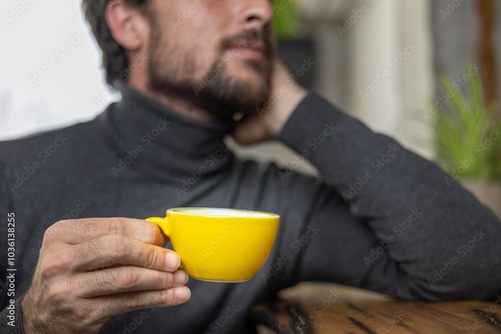 Close-up happy young man smiling in a cafe holding a cup of matcha tea, art with heart shape milk, cappuccino coffee with foam and heart, espresso coffee, decoration with plants, vegan hot drink Close-up happy young man smiling in a cafe holding a cup of matcha tea, art with heart shape milk, cappuccino coffee with foam and heart, espresso coffee, decoration with plants, vegan hot drink