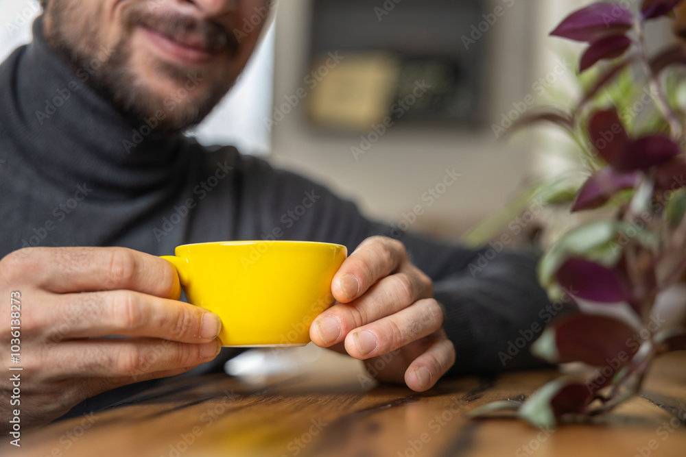 Close-up happy young man smiling in a cafe holding a cup of matcha tea, art with heart shape milk, cappuccino coffee with foam and heart, espresso coffee, decoration with plants, vegan hot drink Close-up happy young man smiling in a cafe holding a cup of matcha tea, art with heart shape milk, cappuccino coffee with foam and heart, espresso coffee, decoration with plants, vegan hot drink