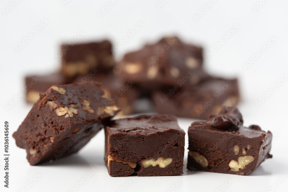 Close Up of Homemade Chocolate Pecan Fudge on a White Background Close Up of Homemade Chocolate Pecan Fudge on a White Background