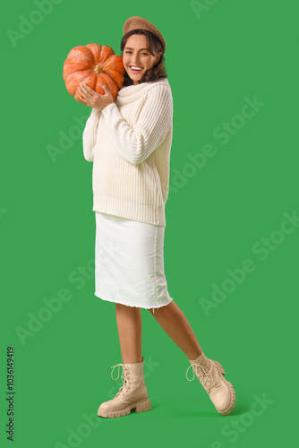 Young woman with pumpkin on...