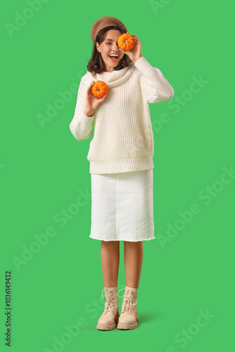 Young woman with pumpkins o...