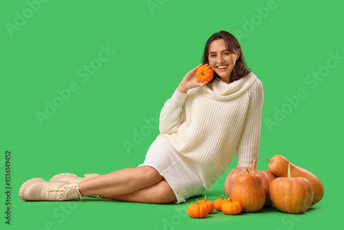 Young woman with pumpkins s...