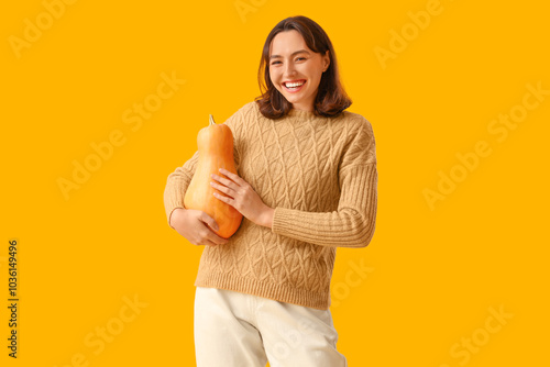 Young woman with pumpkin on...
