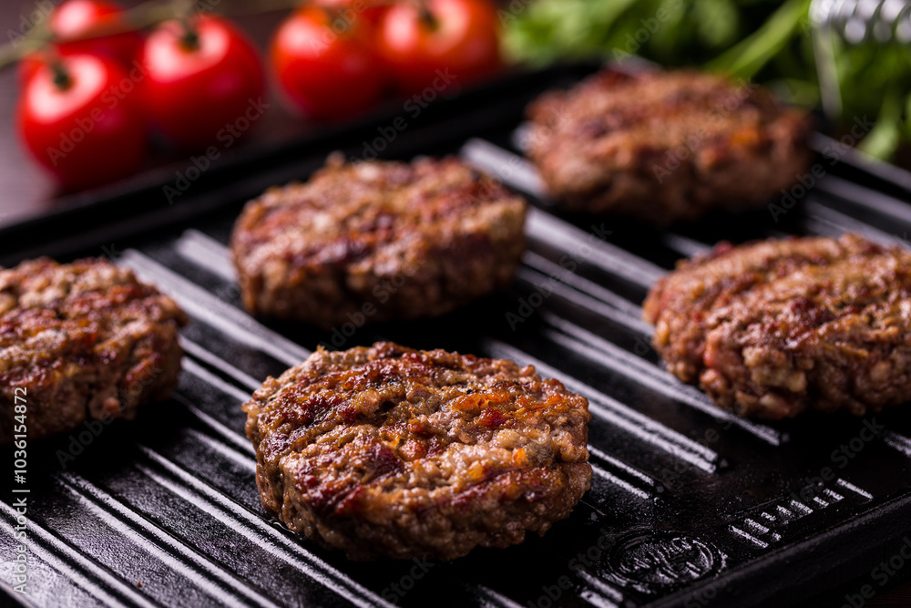Juicy Grilled Beef Patties on a Cast Iron Grill Pan Juicy Grilled Beef Patties on a Cast Iron Grill Pan