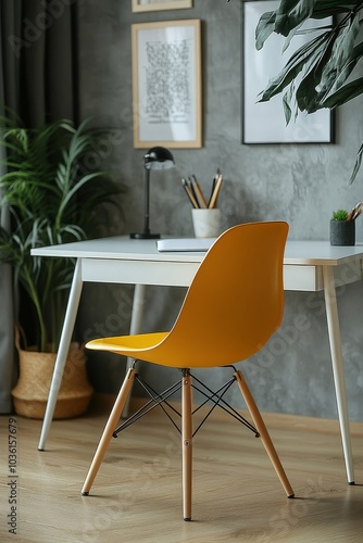 Bright yellow chair beside a modern desk in a stylish home office with plants...