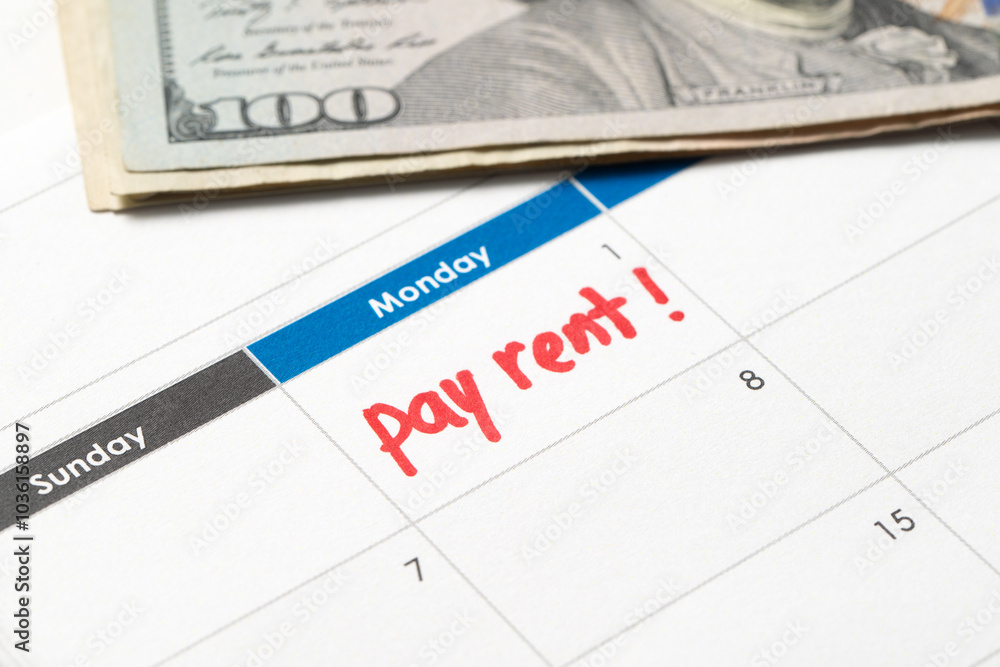 Pay rent reminder written on calendar Pay rent reminder written on calendar