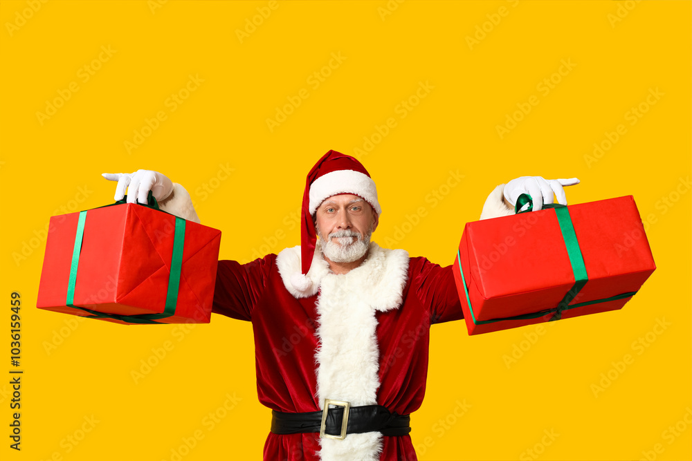 Santa Claus with gift boxes on yellow background Santa Claus with gift boxes on yellow background