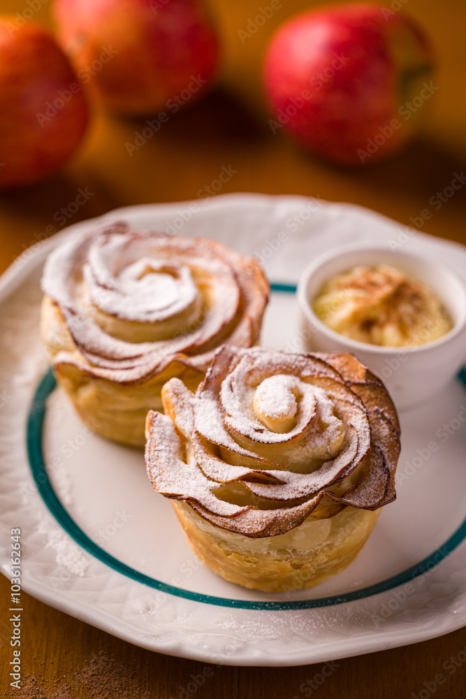 Delicious Apple Rose Pastries with Powdered Sugar on Plate Delicious Apple Rose Pastries with Powdered Sugar on Plate