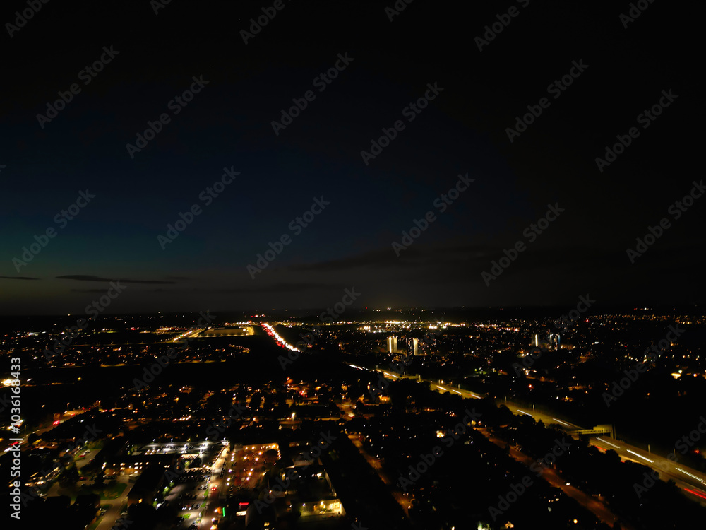 Fototapeta premium Aerial View of Illuminated Luton City of England UK at Just After Sunset and Full Moon Night. Aerial Footage Was Captured with Drone's Camera on October 17th, 2024