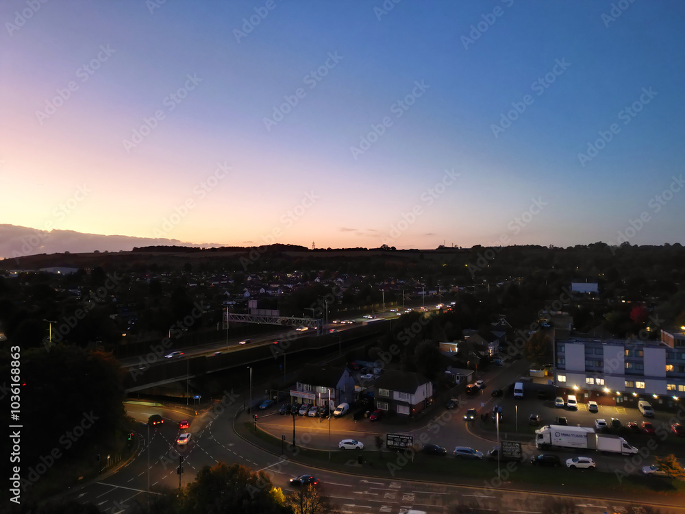 Fototapeta premium Aerial View of Illuminated Luton City of England UK at Just After Sunset and Full Moon Night. Aerial Footage Was Captured with Drone's Camera on October 17th, 2024