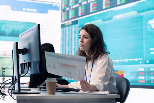 Enterprise worker examines project updates and details in control room, allocate resources and solve tasks to achieve strategic business goals, organizational corporation operations.