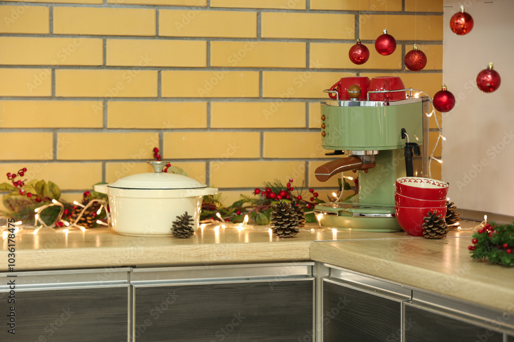 Coffee machine with dishes and Christmas decor on counter in kitchen Coffee machine with dishes and Christmas decor on counter in kitchen