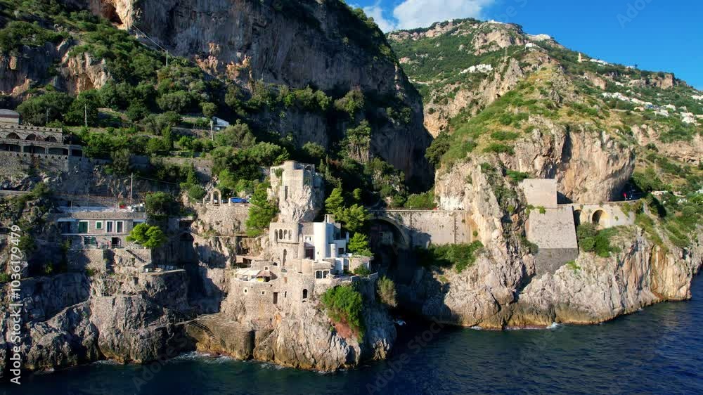 4K Aerial view of very unique bridge over a beach in narrow cliffs on a beautiful sunny day. Famous tourist attraction Fiordo di Furore on the picturesque Amalfi coast in Italy 4K Aerial view of very unique bridge over a beach in narrow cliffs on a beautiful sunny day. Famous tourist attraction Fiordo di Furore on the picturesque Amalfi coast in Italy