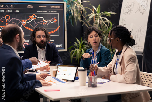 Photography Colleagues evaluating infographics data analysis in an executive meeting, corporate restructuring or organizational changes