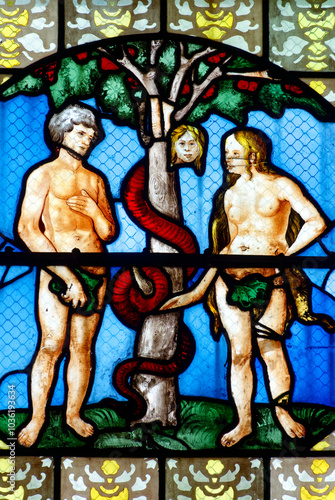 2024-10-16, Auxerre, FRANCE. Stained glass (17th century) of Adam and Eve in paradise tempted by the snake. photo