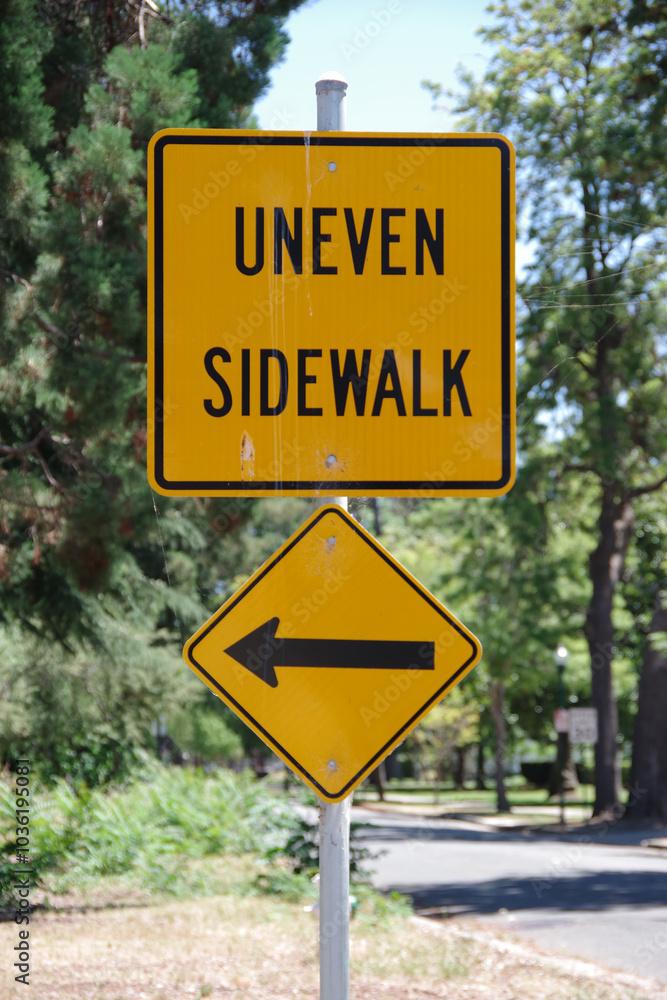 Warning sign UNEVEN SIDEWALK with arrow left Warning sign UNEVEN SIDEWALK with arrow left
