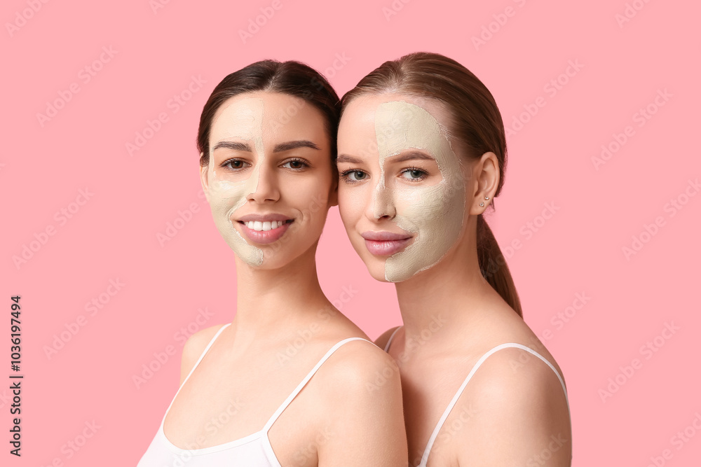 Beautiful young happy women with facial masks on pink background Beautiful young happy women with facial masks on pink background