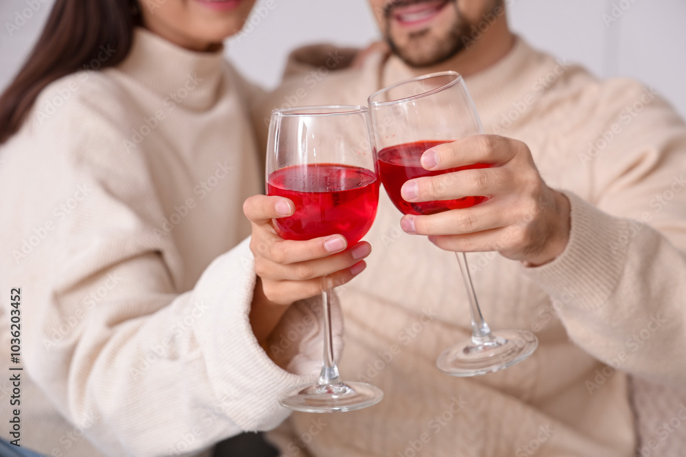 Young couple with glasses of wine at home on autumn day, closeup Young couple with glasses of wine at home on autumn day, closeup