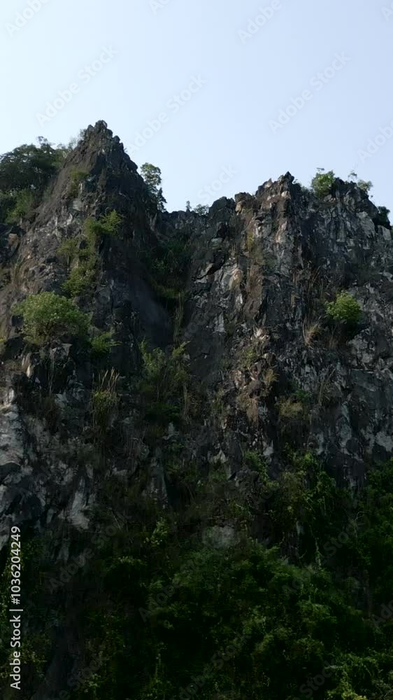 panoramic view of the large rocky mountain and the vegetation that emerges between the stones in Vietnam panoramic view of the large rocky mountain and the vegetation that emerges between the stones in Vietnam