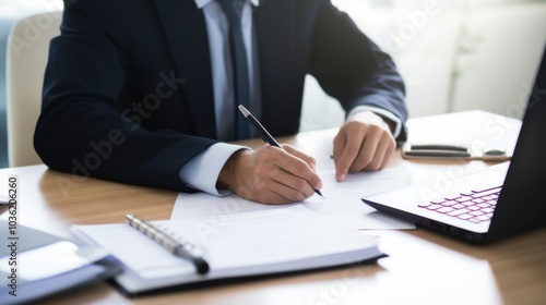 In a well-lit office, an accountant in a suit meticulously reviews financial documents, surrounded by a laptop and stationery, symbolizing precision and focus.