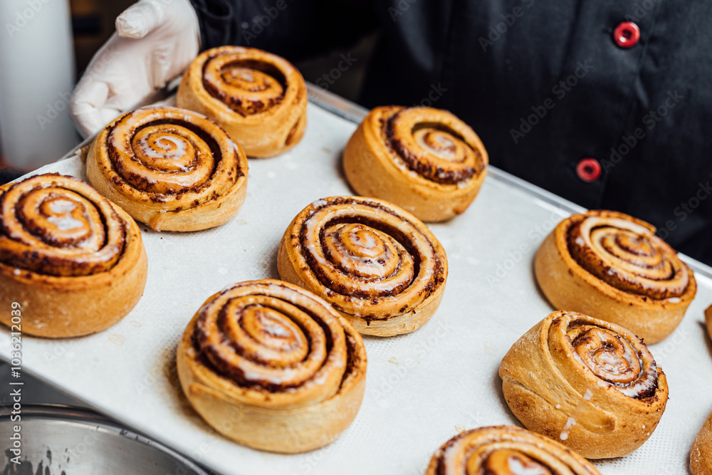 Freshly baked cinnamon rolls on a kitchen tray Freshly baked cinnamon rolls on a kitchen tray