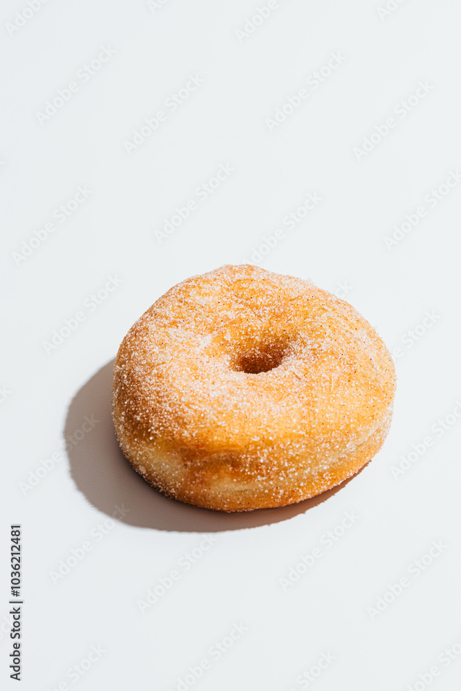 Classic donut with sugar and cinnamon coating Classic donut with sugar and cinnamon coating